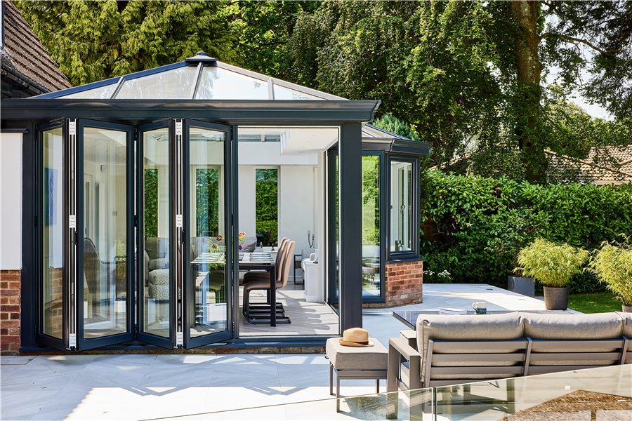 Anthracite Grey Conservatory with Bi-Fold Doors and Garden Seating Area