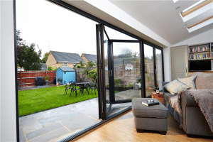 Large 5-panel aluminium bifold door fully open from living room to garden