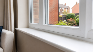 White uPVC window with clean internal ledge and external sill detail in a UK home